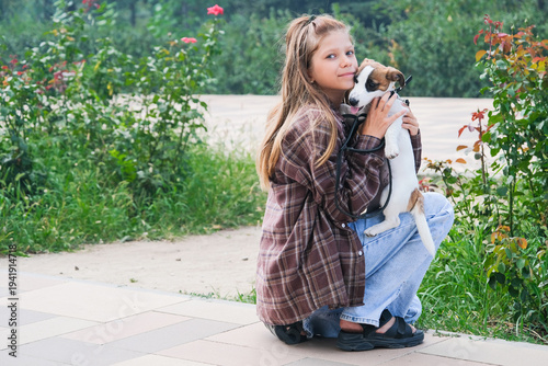 teenager girl walking her dog in the park