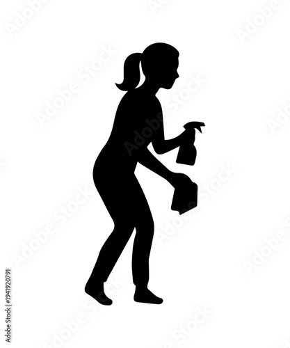 Woman silhouette cleaning surface with spray bottle