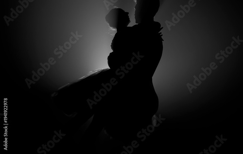 Graceful ballerina and her male partner dancing elements of classical or modern ballet in dark with floodlight backlight. Couple in smoke on black background. Art concept.