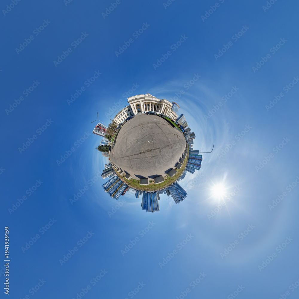 Naklejka premium simple little tiny planet with buildings in blue sky with sun and beautiful clouds. Transformation of spherical panorama 360 degrees. Spherical abstract aerial view. Curvature of space.