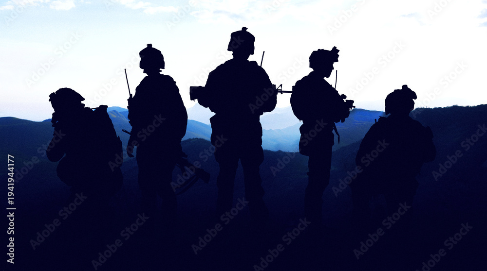 Naklejka premium Soldiers stand in silhouette against mountains during the Iran USA conflict in the evening