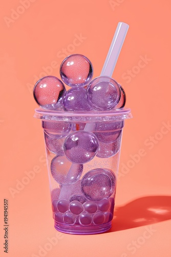 Colorful drink with jelly balls in a clear cup on a bright background