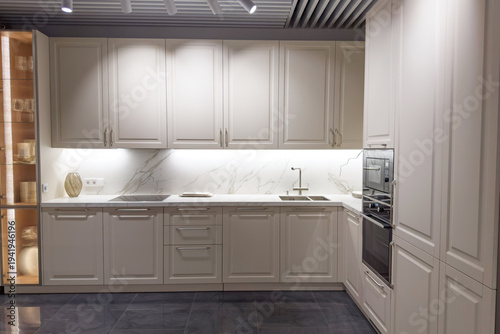 Modern kitchen design featuring sleek cabinetry and elegant marble countertops with stylish lighting