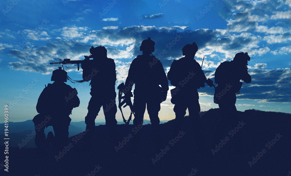 Naklejka premium Military personnel stand silhouetted against the sky during a conflict involving Iran and USA