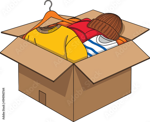 Donation box with clothes and hat for charity support, cardboard package filled with second hand garments for clothing donation and humanitarian aid concept