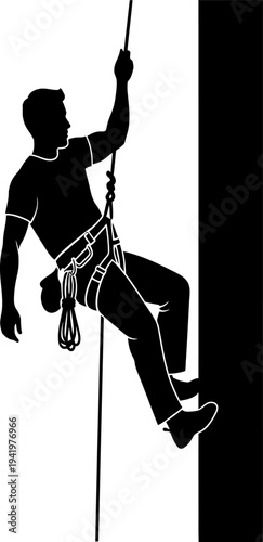 Silhouette of a rock climber in action on a vertical wall