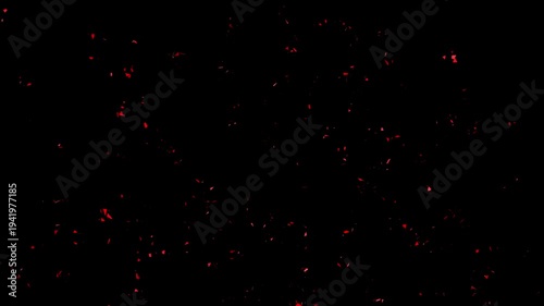 Red confetti explosion and flying particle shards on black background