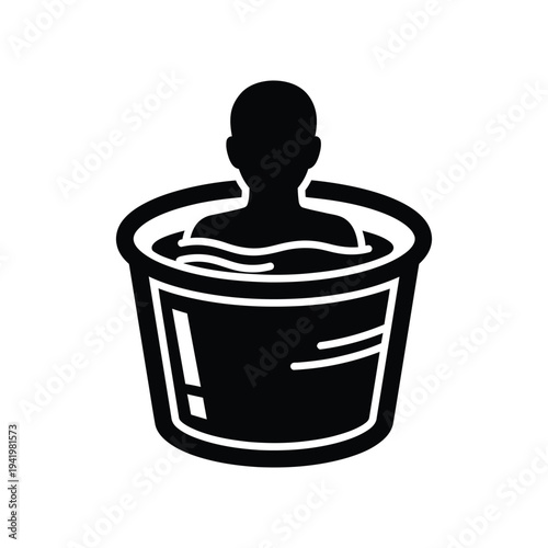 Silhouette of a person relaxing in a round bathtub filled with water