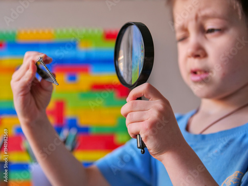 Принти на полотні Curious Boy Examining Metal Screw With Tweezers and Magnifying Glass, Child Scie