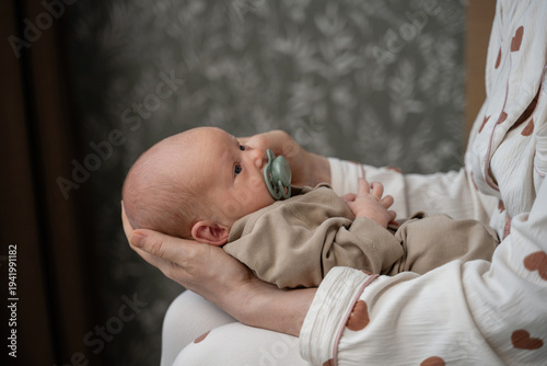 Gentle embrace of newborn in cozy home setting