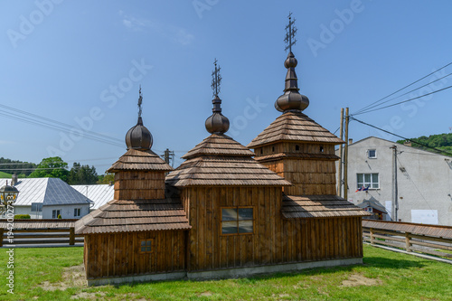 Картината върху платно Small wooden church with three onion domed towers in the style of traditional Ca