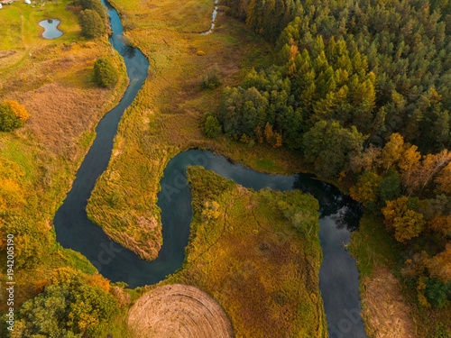 Bild auf Leinwand Winding Radunia river flowing through autumn landscape in Kashubia, Poland