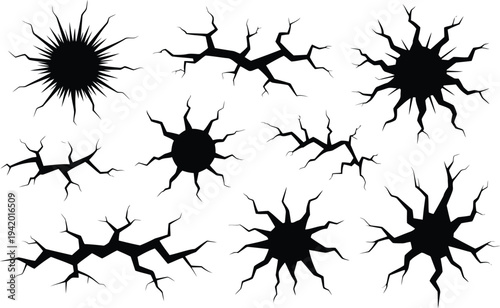 A striking collection of various black crack and impact hole silhouettes on a clean white surface