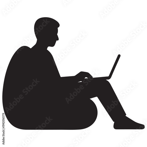 Silhouette of a person typing on a laptop while relaxing in a comfortable bean bag chair.