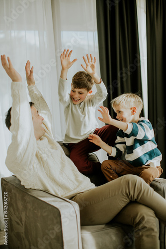 Two boys play with their fa...