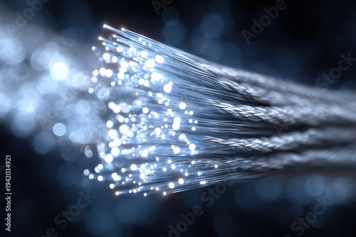 Close-up shot of fiber optic cables transmitting data, showcasing a network technology for fast and reliable communication with blurred lights, dark background.