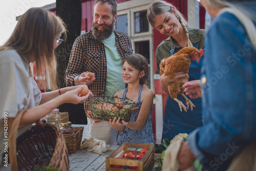 Buying organic produce and eggs at local farmers market.