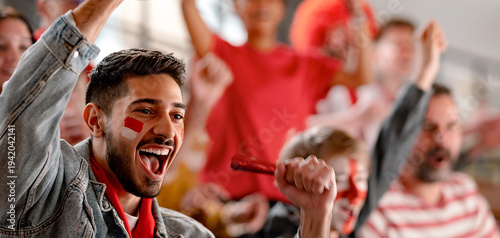 фотографія Excited football fans supproting Austrian national team in live soccer match at stadium