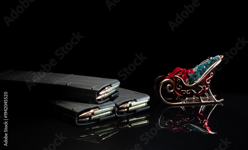 Room for text above a sleigh Christmas ornament on loaded gun magazines