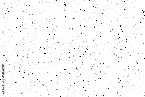 A rough aged surface covered with randomly distributed black grunge speckles and subtle distress marks
