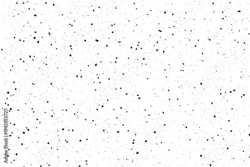 Countless tiny black points are randomly distributed across a pristine white background forming a unique textural pattern