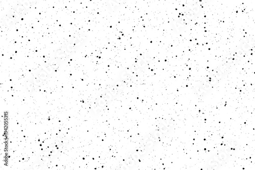 A simple pattern of scattered black speckles creates a textured appearance on a clean white surface