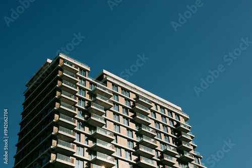 Schilderij op canvas Modern residential tower with repeating balconies and clean geometric facade
