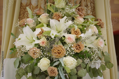 Floral arrangement in shades of brown. Brown roses and eucalyptus branches adorning an important ceremony