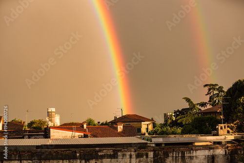 Wallpaper Mural Vibrant Vertical Rainbow Over European Rooftops at Golden Hour Torontodigital.ca