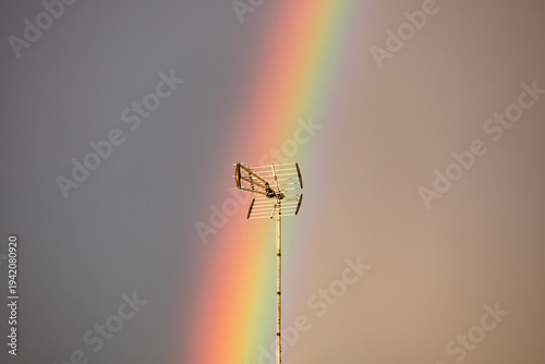 Wallpaper Mural Vibrant Vertical Rainbow Over European Rooftops with Antenna at Golden Hour Torontodigital.ca