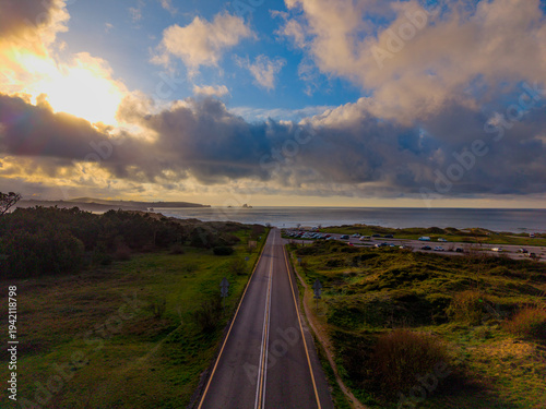 Panoramic aerial shot of the scenic road to Valdearenas beach in the Liencres Dunes Natural Park. Awesome route close to the sea in a golden sunset in North of Spain.
