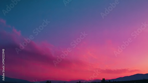 Vibrant magenta and deep blue hues dominate the twilight sky above a silhouetted landscape.