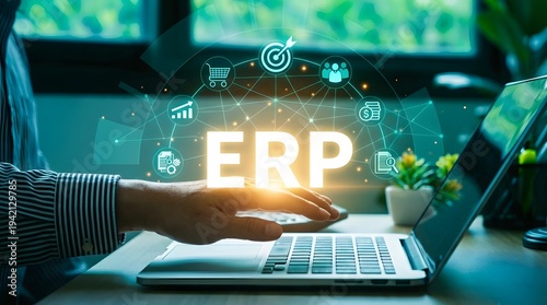 Business professional using ERP software on laptop with digital transformation icons and futuristic glow in modern office