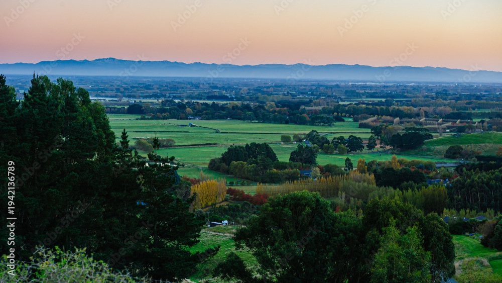 Fototapeta premium Golden Light Over Rolling Hills and Farmland Near Lake Tekapo, New Zealand 