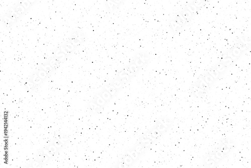 A clear image of many tiny black spots randomly placed on a bright white background generating a unique pattern