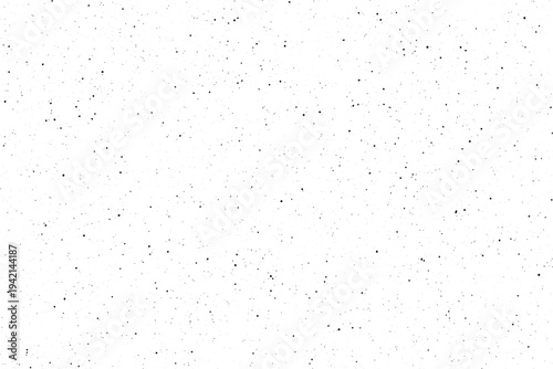 A field of scattered black points covers a pristine white surface providing a subtle speckled visual