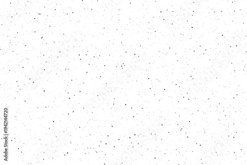 A sparse array of small black particles covers a bright white empty space
