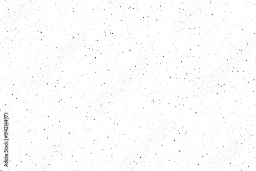 An intricate array of small black particles creates a fine speckled pattern over a stark white area