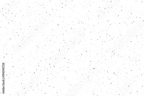 Numerous tiny black dots are scattered randomly across a bright clean white surface