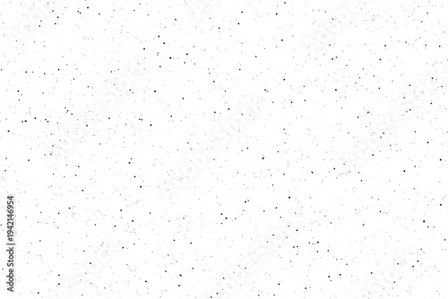 Numerous small black specks are evenly dispersed across a pristine white canvas