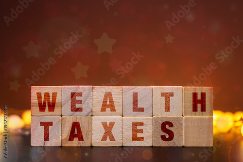 Фотография Progressive Wealth Tax Reform Policy Concept with Wooden Blocks on Dark Backgrou