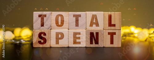 Wooden blocks spelling total spent for personal budgeting and household expense tracking