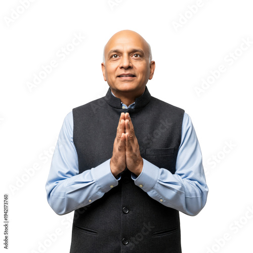 Senior Indian man in traditional Nehru jacket performing Namaste greeting gesture