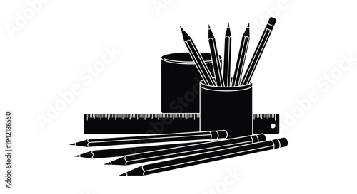 Drawing utensils including sharpened pencils and rulers are neatly arranged for.