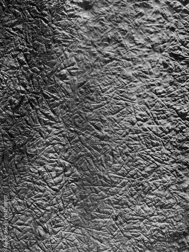 Abstract frozen texture with chaotic ice crystal patterns forming a natural winter background. Close-up of frost structures on a cold surface creating a monochrome organic texture with intricate lines