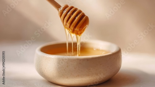 Golden Honey Dripping from Wooden Dipper into Bowl