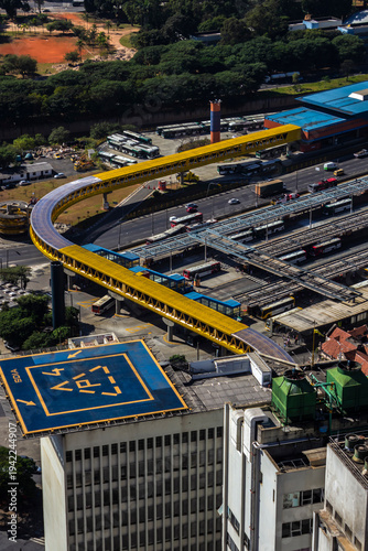 Aerial view of the bustling Dom Pedro II Park bus terminal. The image captures the city's vast public transport network, with its iconic yellow walkway, station.