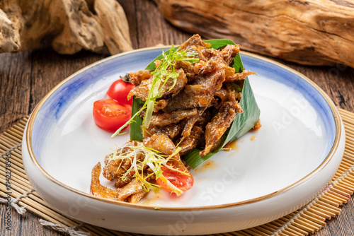 Tableau sur toile Black bean dace served on a white porcelain plate
