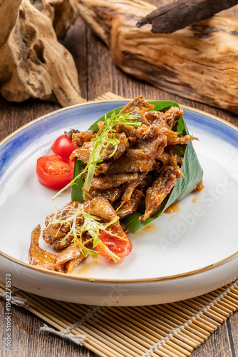 Tableau sur toile Black bean dace served on a white porcelain plate