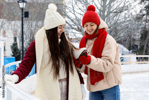 Happy female friends with i...